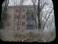 Огонек в окне над морозным узором